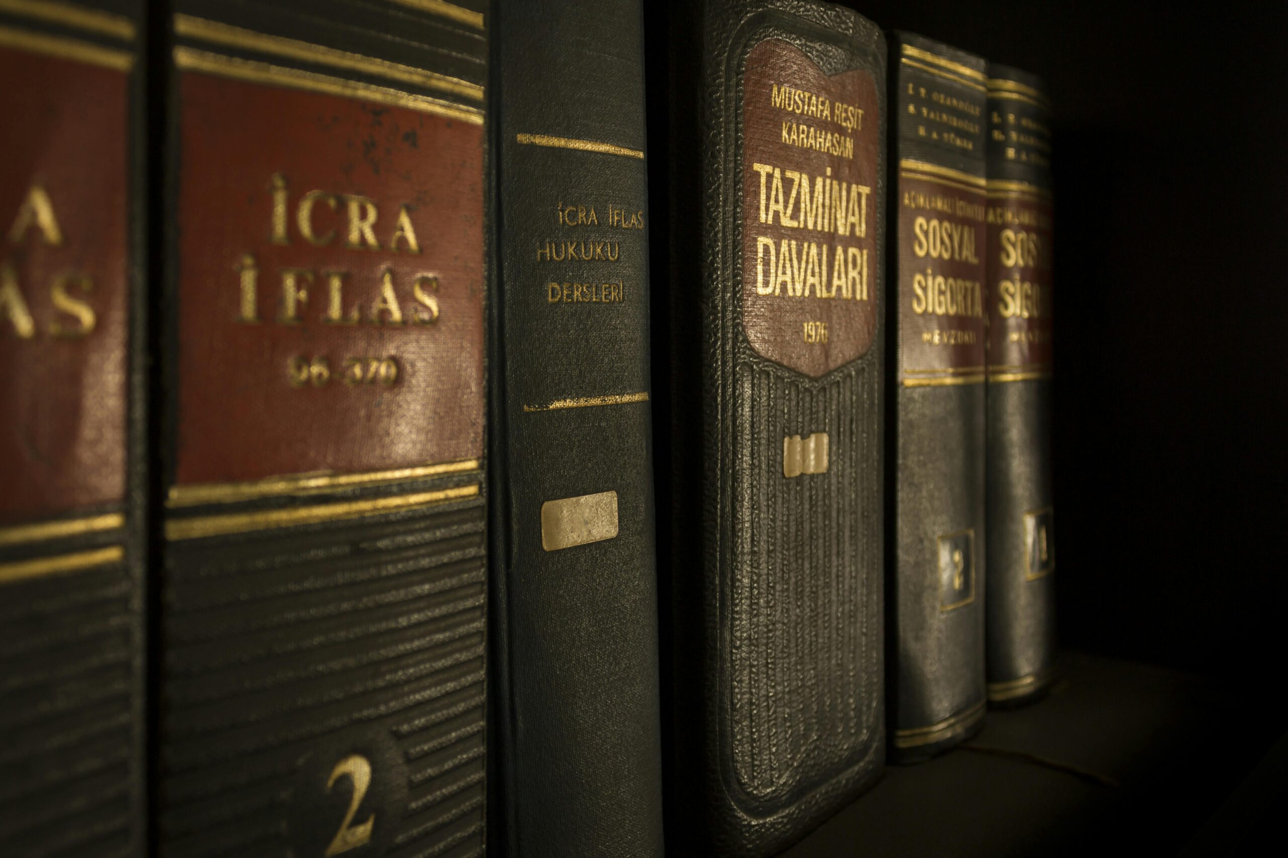 Detailed close-p of law and regulation books on a bookshelf, emphasizing education and knowledge.